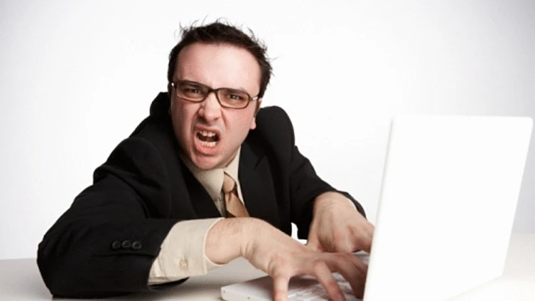 אדם כועס יושב מול מחשב