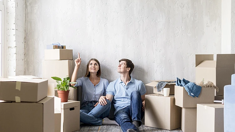 Couple Pointing Up While Packi