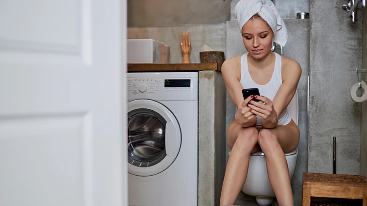 Young,woman,with,constipation,or,diarrhoea,sitting,on,toilet,with