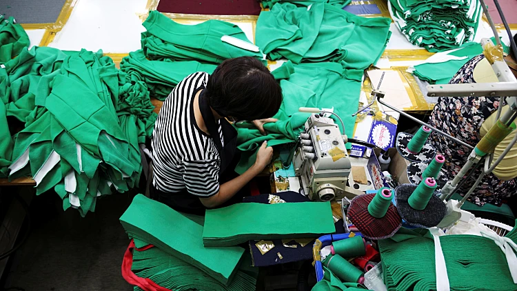 A Woman Works On Tracksuits Inspired By Netflix Series "squid Game" At A Clothing Factory In Seoul