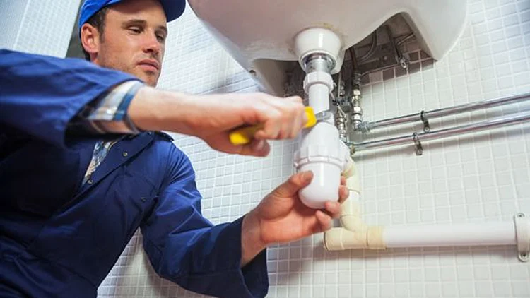 Frowning Plumber Repairing Sin
