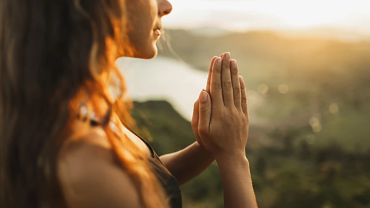 Woman,praying,alone,at,sunrise.,nature,background.,spiritual,and,emotional