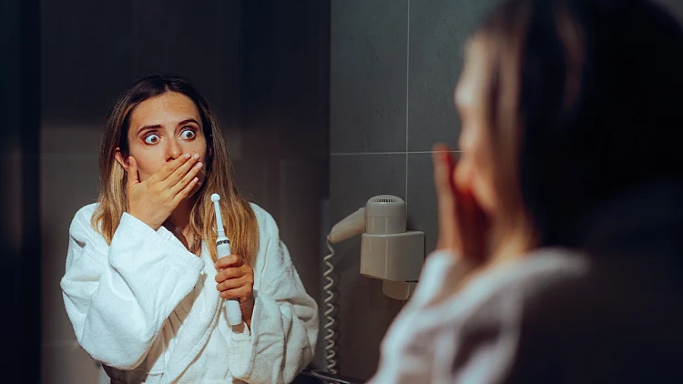 Woman,brushing,her,teeth,feeling,pain,and,sensitivity.,sad,concerned