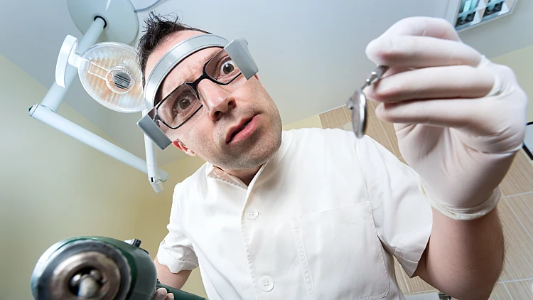 Crazy,dentist,ready,to,drill,approached,the,patient,and,dental