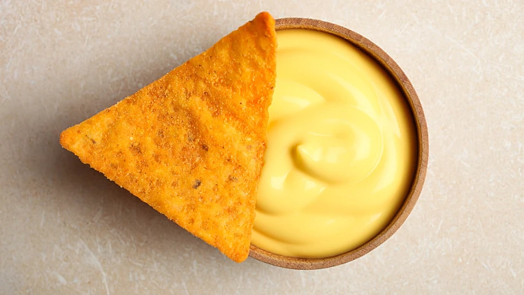 Mexican,crispy,snack,,nachos,chips,and,cheese,sauce,on,neutral
