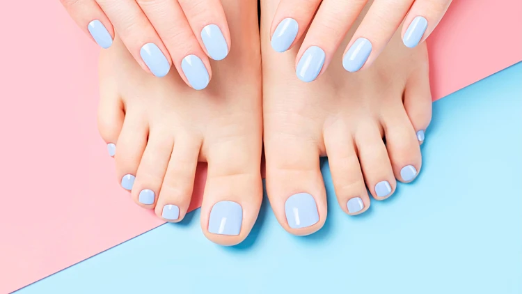 Female,hands,and,feet,with,light,blue,manicure,and,pedicure