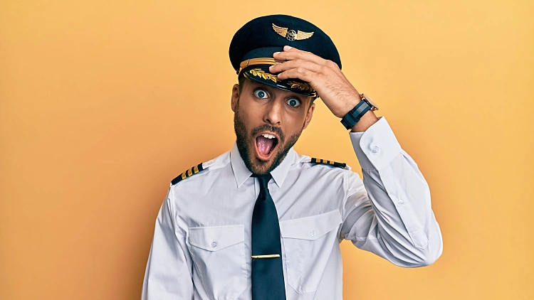 Handsome,hispanic,man,wearing,airplane,pilot,uniform,surprised,with,hand