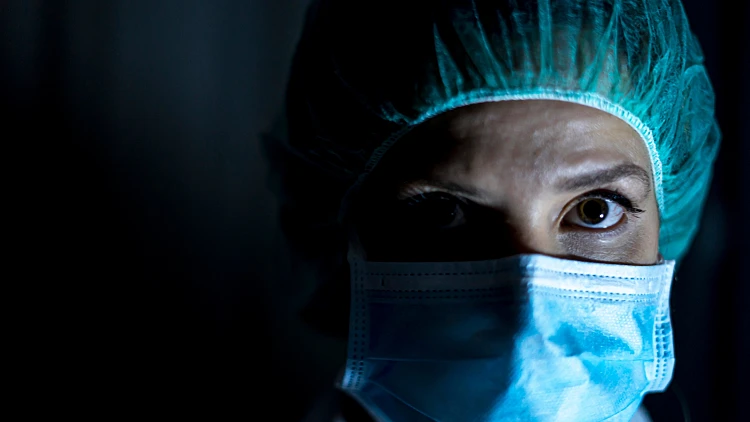Portrait,of,young,female,surgeon,,wearing,mask,and,a,surgical