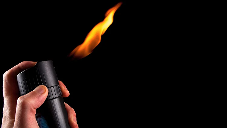 Fire,burning,out,of,deodorant,spray,in,hand,isolated,on