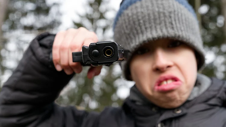Angry,boy,pointing,gun,with,aggressive,facial,expression,,symbol,of
