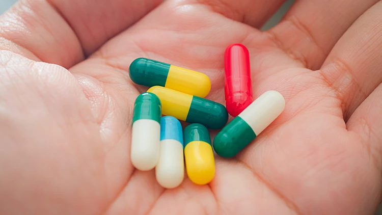 Diverse,prescription,pills,and,multi Colored,capsules,in,hand:,a,concept