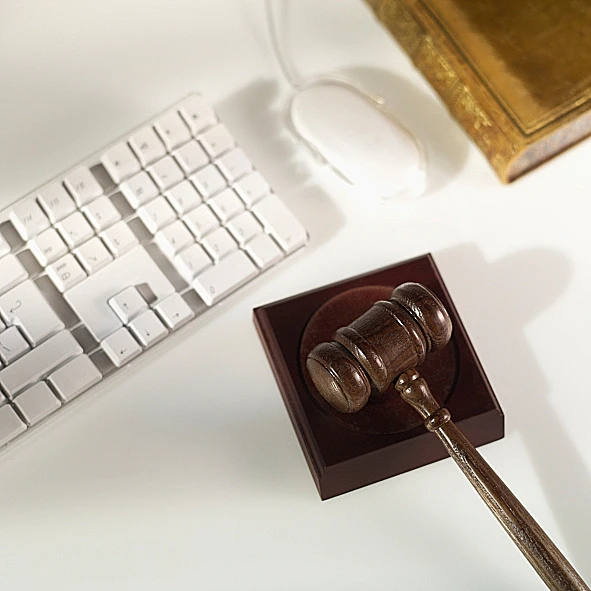 פטיש שופטים מונח לצד מקלדת ומחשב