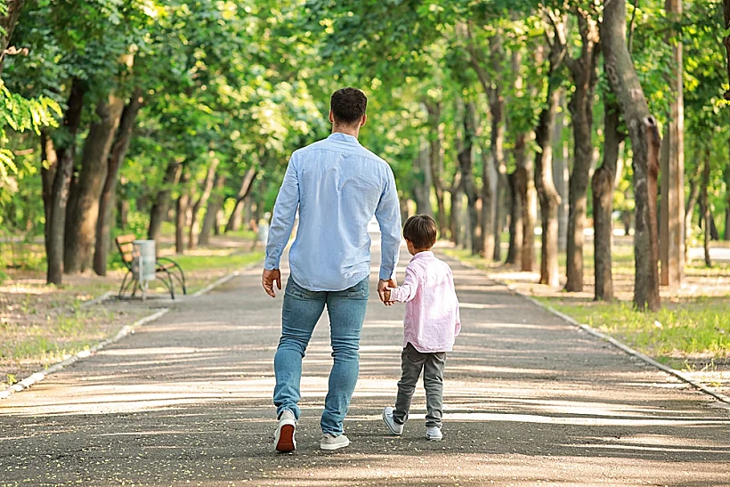 Father,walking,with,his,little,son,in,park