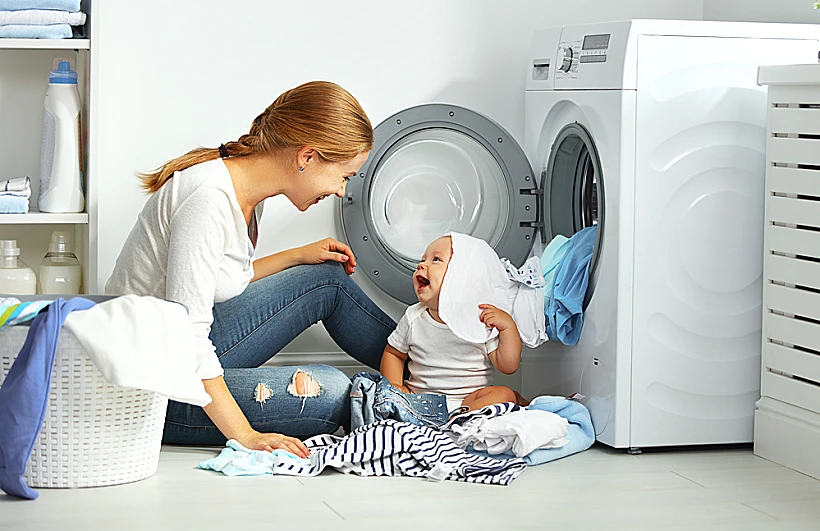 Mother,a,housewife,with,a,baby,engaged,in,laundry,fold