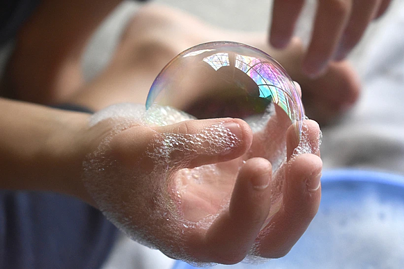 Little,boy,playing,blowing,and,making,soap,bubbles,holding,bubble