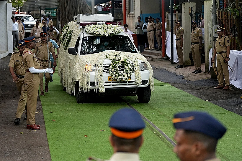 A Hearse Van Carrying The Body Of Former Chairman Of Tata Group Ratan Tata, Moves Past Police Officers On The Day Of His Funeral In Mumbai
