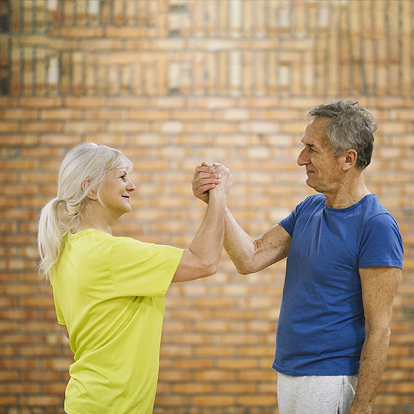 Older Couple Shaking Hands Gym