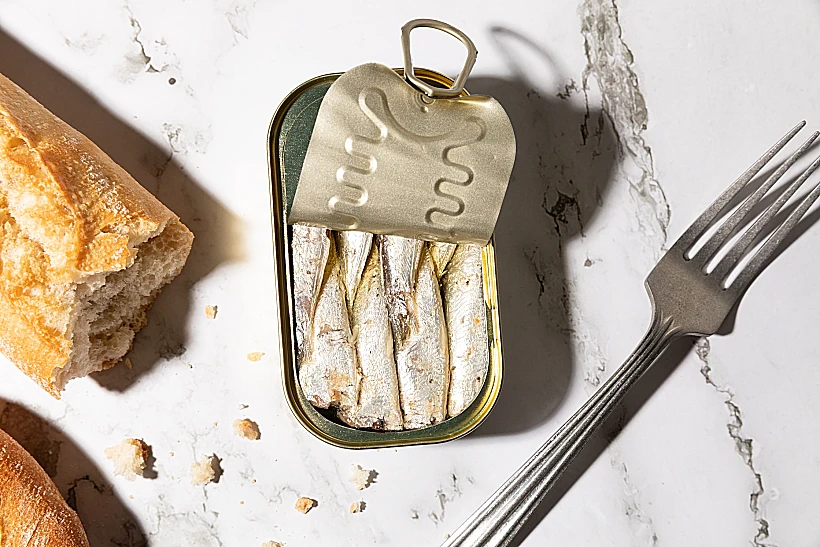 Canned,sardines,and,bread,isolated,on,kitchen,countertop