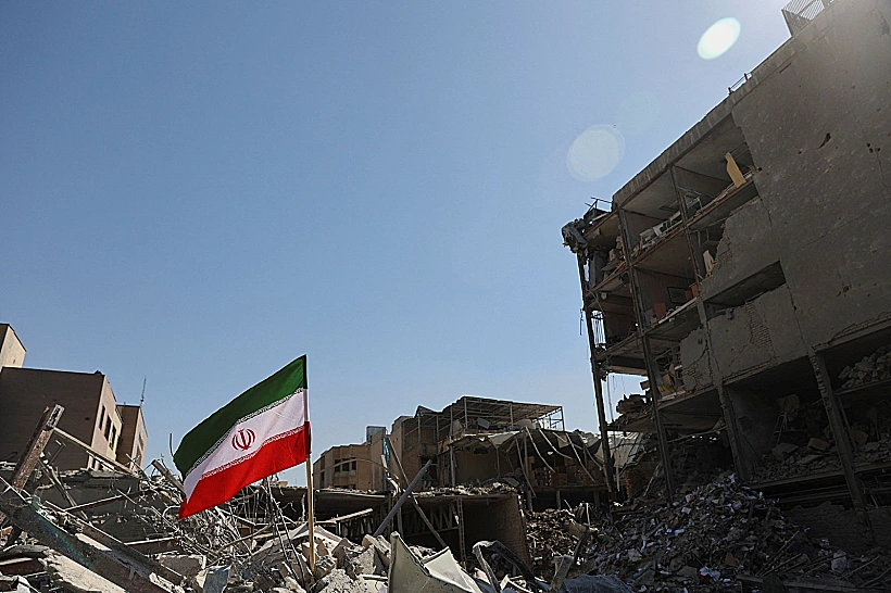 דגל איראן ברקע הרס בטהרן