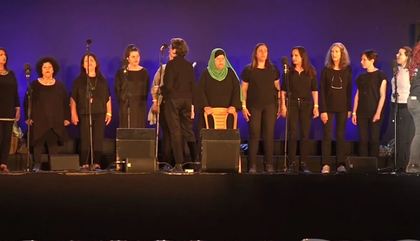 להקה של יהודיות ופלסטינאיות שרות שיר על הבמה בטקס יום הזיכרון הישראלי-פלסטיני