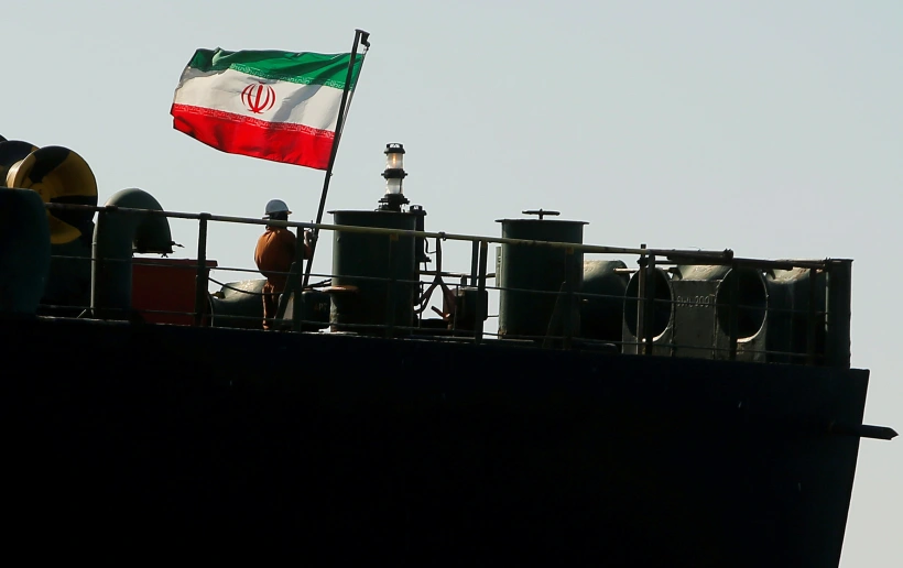 A Crew Member Raises The Iranian Flag On Iranian Oil Tanker Adrian Darya 1, Previously Named Grace 1, As It Sits Anchored After The Supreme Court Of The British Territory Lifted Its Detention Order, In The Strait Of Gibraltar