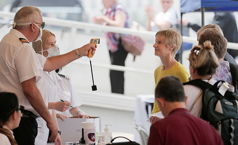 Tourists Are Checked With A Thermal Scanner By An Officer, As They Board To A Cruise Ship, Following An Outbreak Of The New Coronavirus, In Colombo