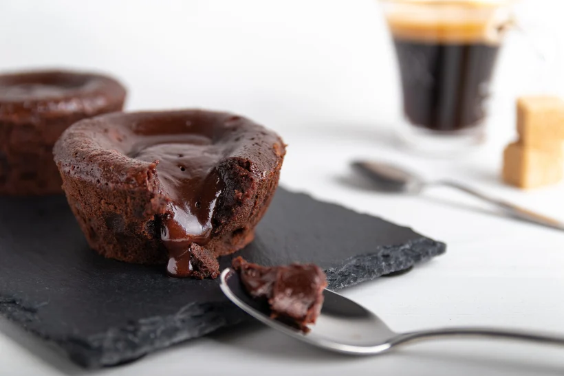 Homemade,chocolate,lava,cake,on,a,black,plate,with,a