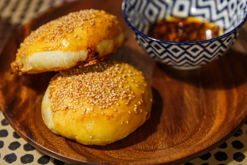 Xinjiang,grilled,buns,with,lamb,stuffing,on,a,wooden,plat