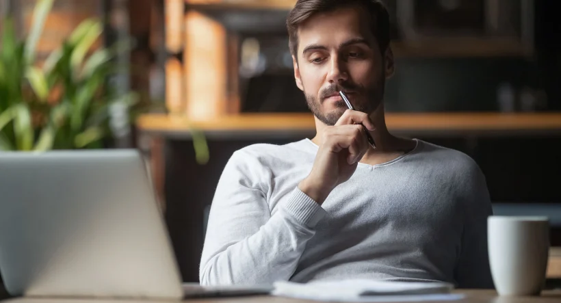 Pensive,bearded,man,sitting,at,table,drink,coffee,work,at