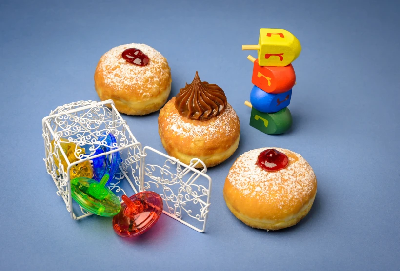 Fresh,donuts,and,dreidels,for,jewish,holiday,hanukkah,celebration.