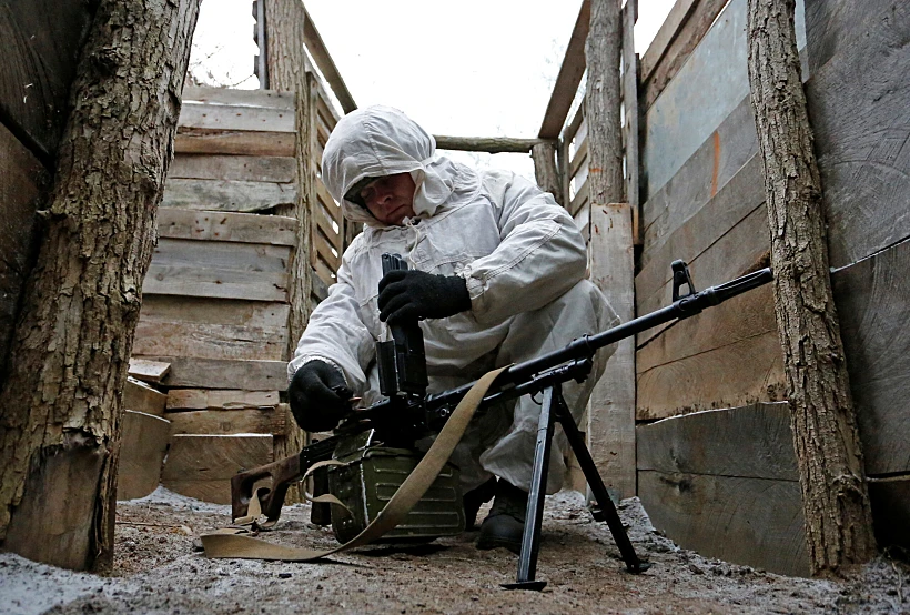 A Militant Of The Self Proclaimed Donetsk People's Republic (dnr) Checks A Machine Gun At Fighting Positions In Donetsk Region