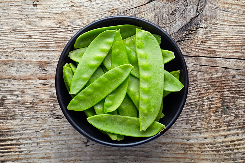 Bowl,of,snow,peas,on,wooden,background,,top,view