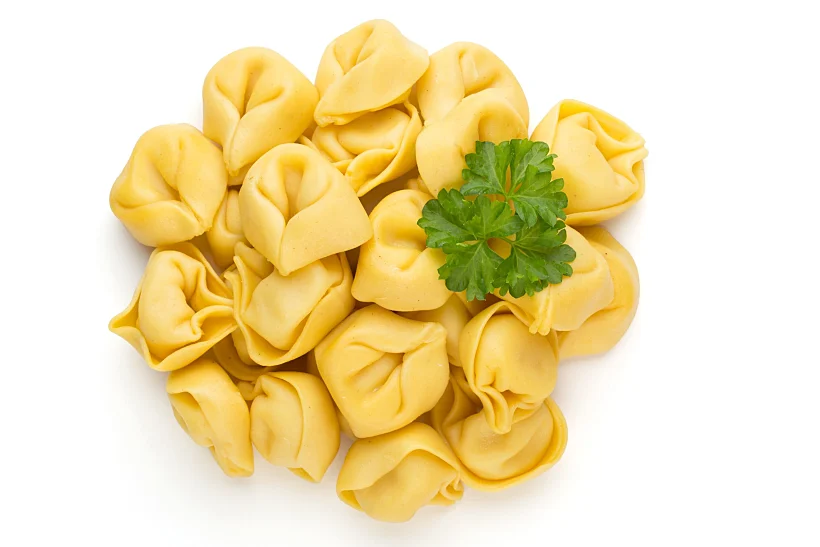 Raw,homemade,pasta,tortellini,with,herbs.