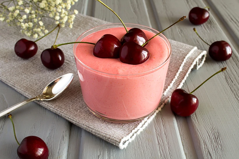 Milk,yogurt,with,cherry,on,the,grey,napkin