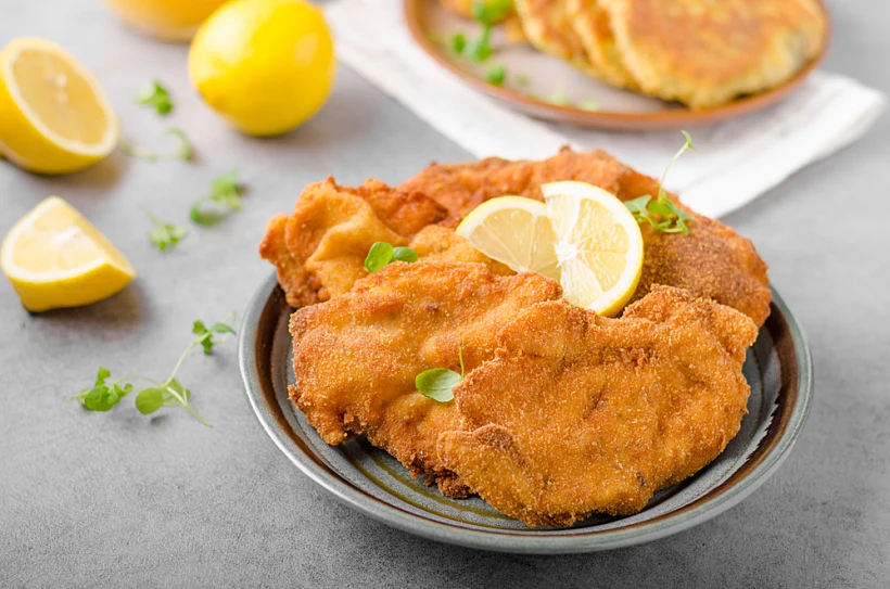 Delicious,original,schnitzel,with,potato,pancakes,,fresh,juice,,pancakes,with