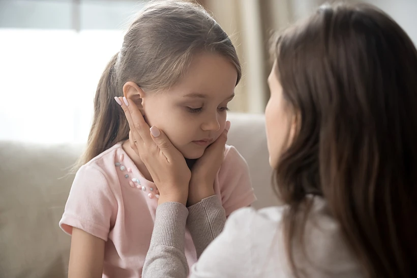 Loving,young,mother,touching,upset,little,daughter,face,,expressing,support,