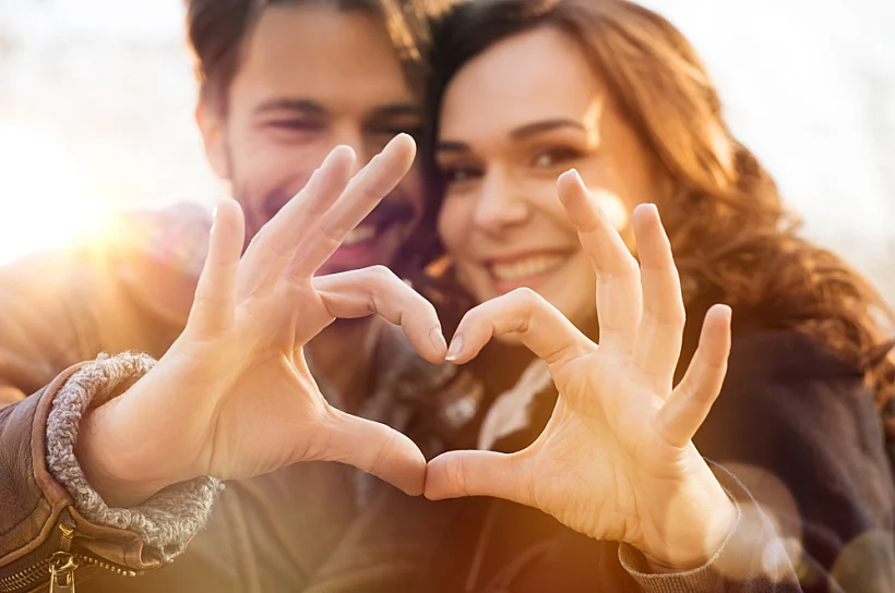 Closeup,of,couple,making,heart,shape,with,hands