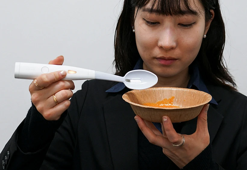 An Employee Of Kirin Holdings Demonstrates An Electric Spoon That Can Enhance The Salty Taste In Food, In Tokyo