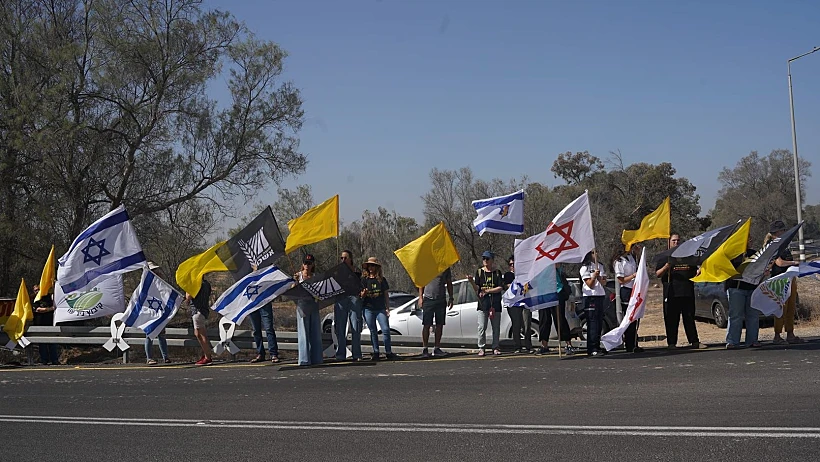 אזרחים מלווים את רונן אנגל בדרכו האחרונה בכניסה לקיבוץ ניר עוז