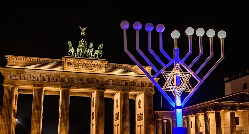 Brandenburg,gate,and,lightning,jewish,menorah,on,a,square,against