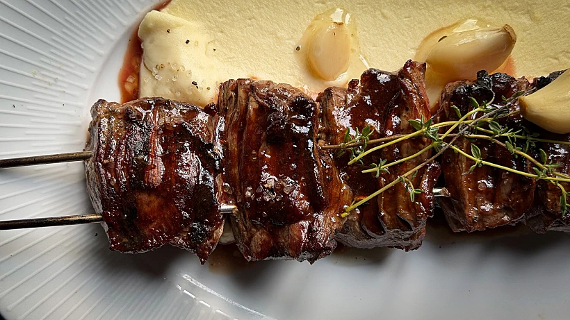 שיפוד נתח קצבים על מצע של גראטן תפוחי אדמה