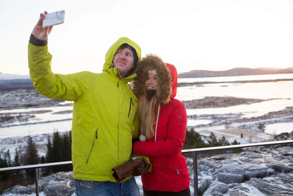 Tourists Enjoy The Golden Circle Tour In Iceland