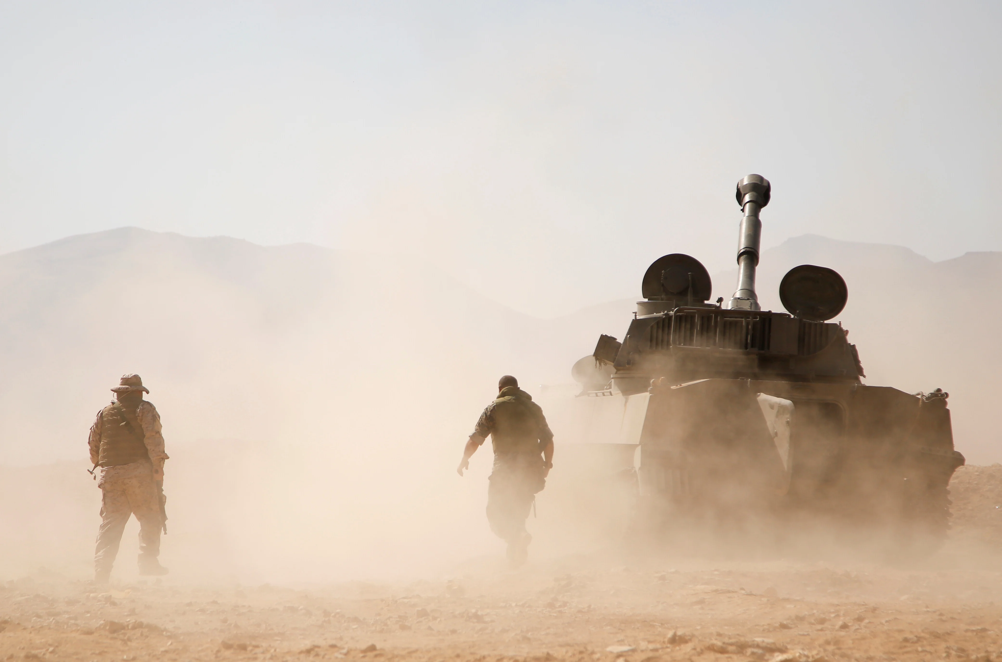 Hezbollah Fighter Walk Near A Military Tank In Western Qalamoun