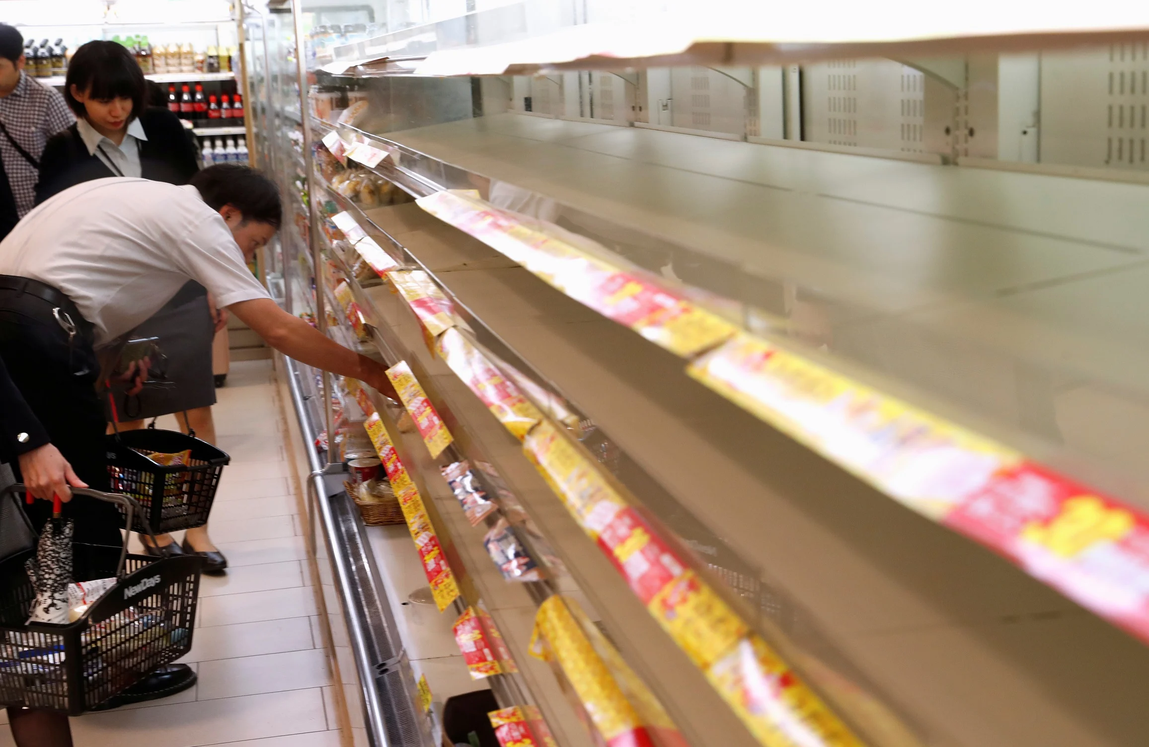 A Customer Looks For Food On The Racks Inside A Convenience Store At Tokyo Station In Tokyo, Japan, Ahead Of Typhoon Hagibis