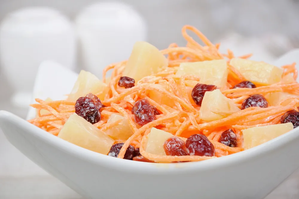 A,salad,of,pineapple,,fresh,carrots,,dried,cranberries,,yogurt,dressed.