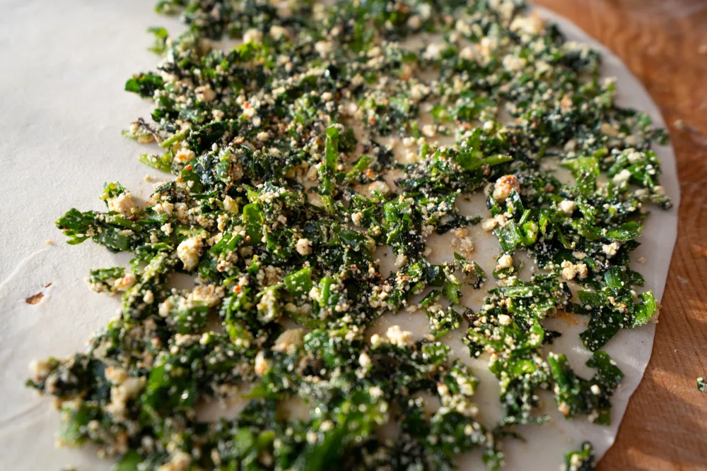 Making,gozleme,dough,by,close,up,female,hands,in,kitchen.