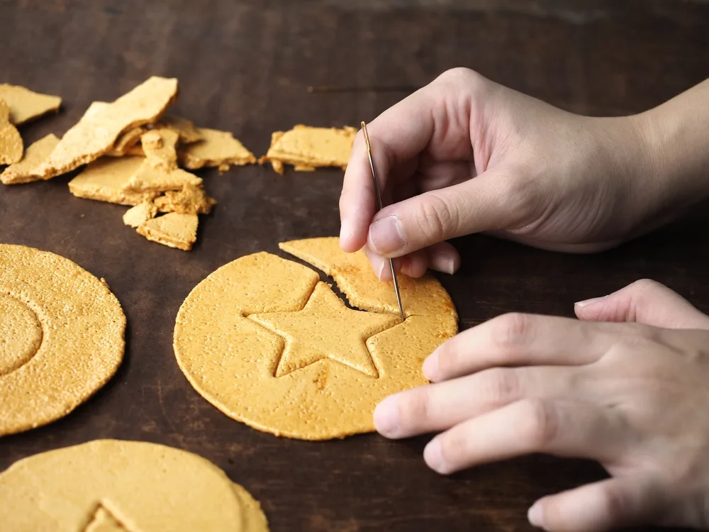 Playing,korean,dalgona,or,ppopgi,candy,game,with,needle.,honeycomb