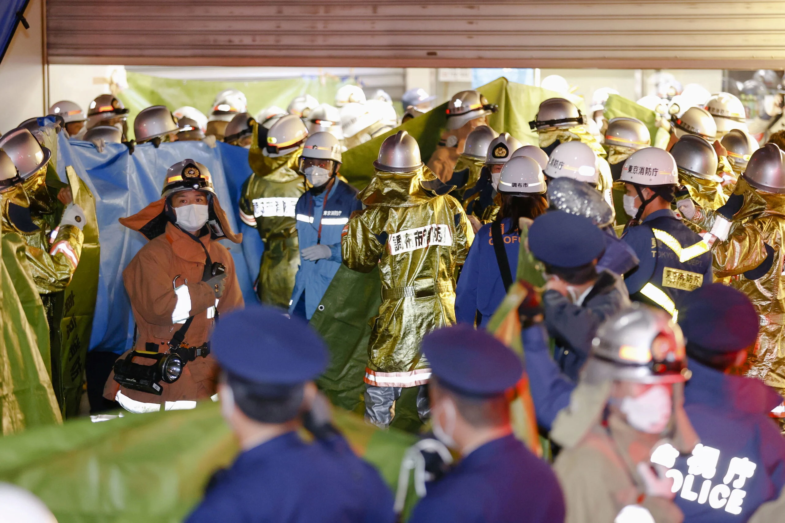 Rescue Workers And Police Officers Work At The Site Where A Knife, Arson And Acid Attack Incident Occurred On A Train, At The Kokuryo Station Of The Keio Line Train In Tokyo