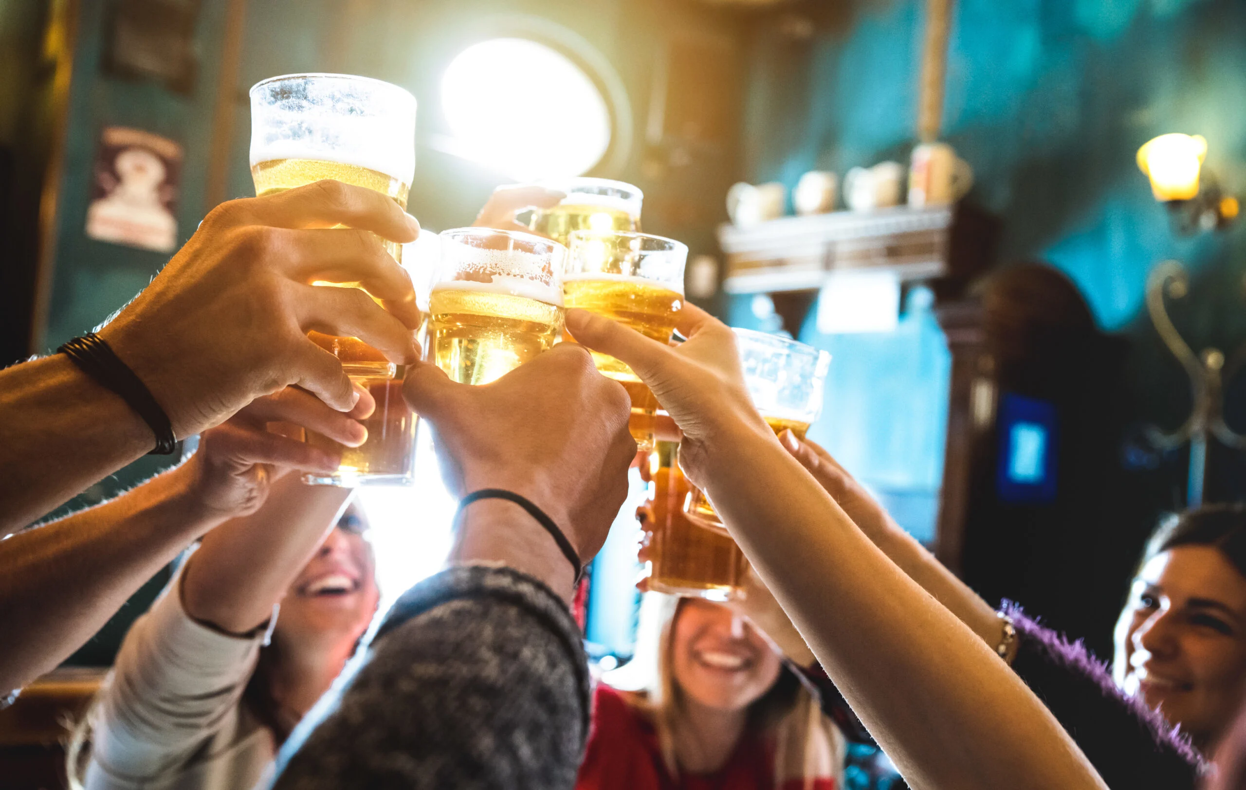 Group,of,happy,friends,drinking,and,toasting,beer,at,brewery