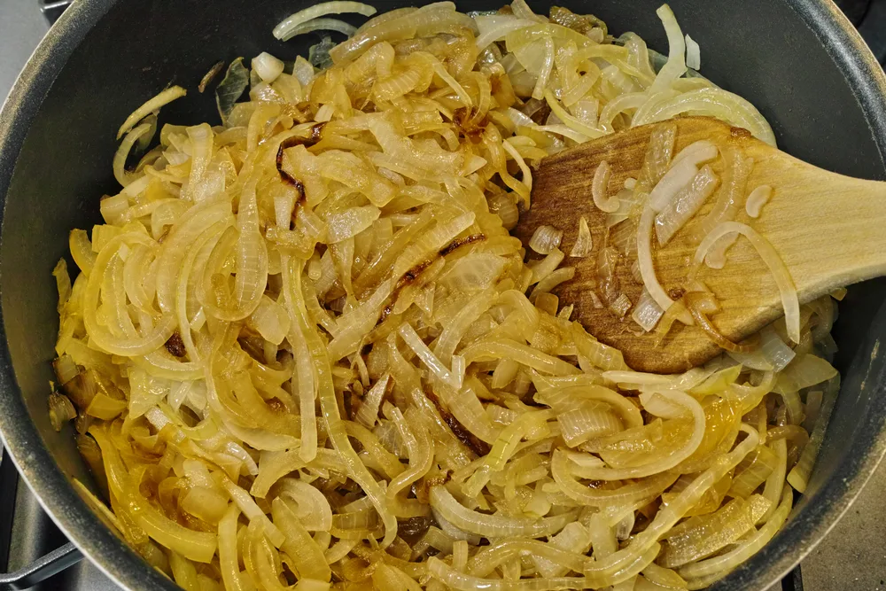 Cooking,onions,in,a,frying,pan